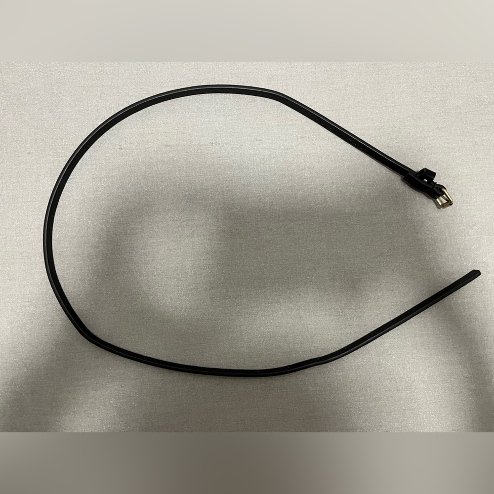 Skinny black belt with gold tone buckle